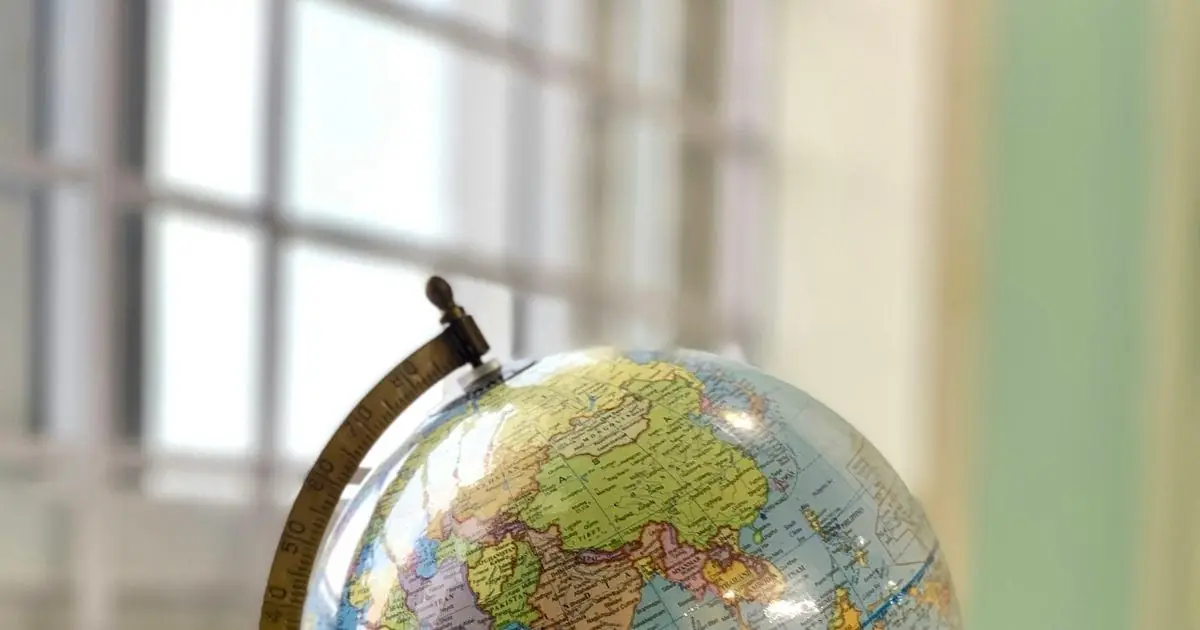 A desk globe standing on a white table